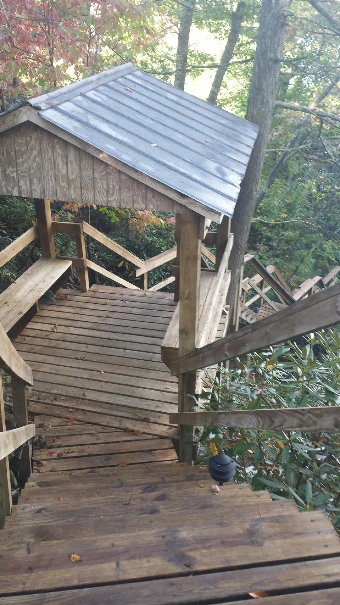 Metal roofed shelter over wooden steps on a wooded walkway — Skylight Repair & Installation work by our crew in Spencertown